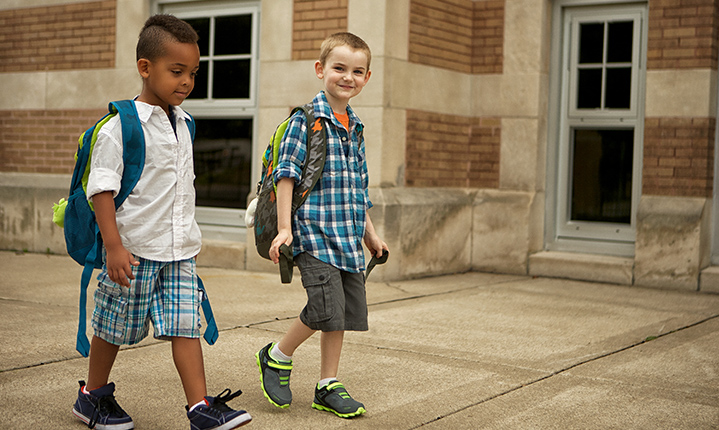 Two kids walking to school.