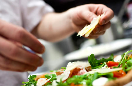 A chef making a pizza.